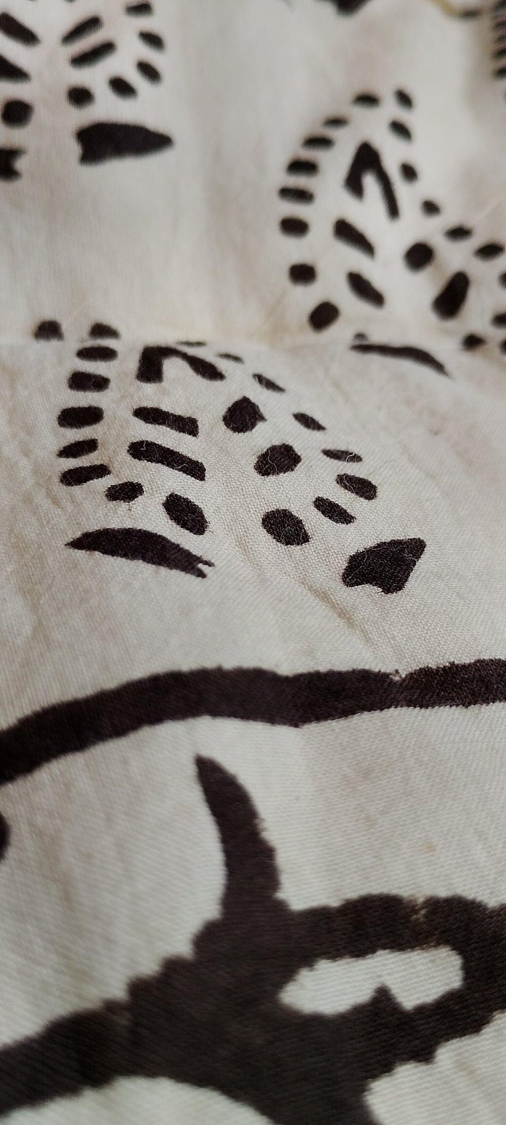 Close-up of a white fabric with dark patterns