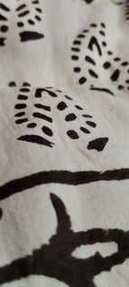 Close-up of a white fabric with dark patterns