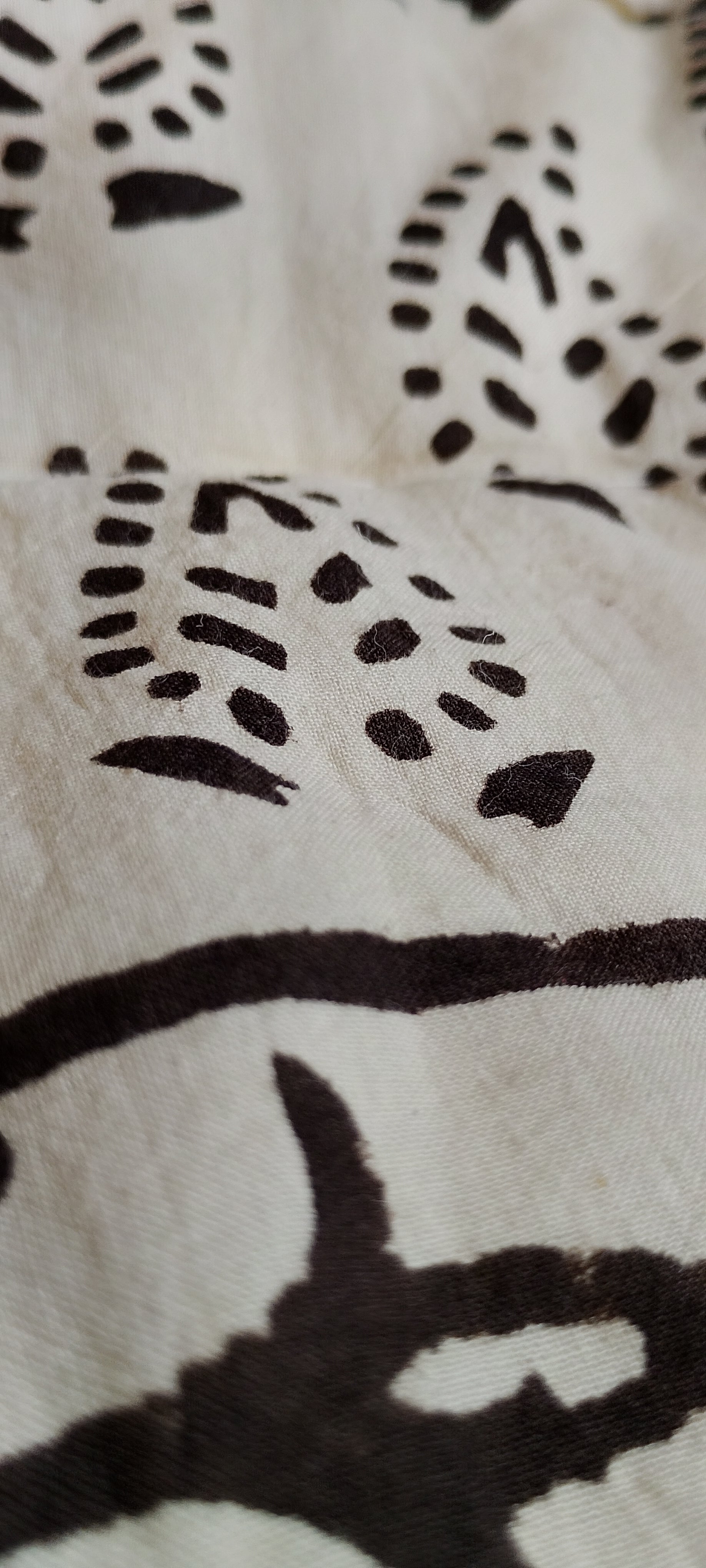 Close-up of a white fabric with dark patterns