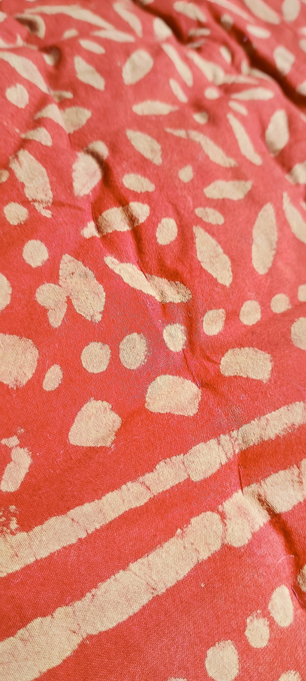 Close-up of a red fabric with light pattern