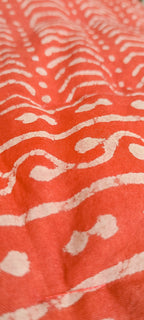 Close-up of a red fabric with white abstract patterns