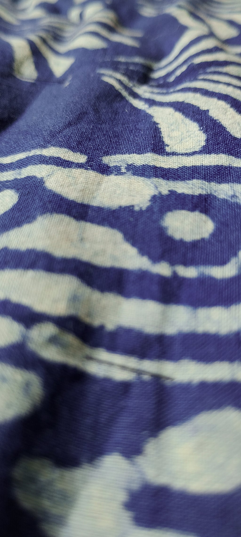 Close-up of blue fabric with white abstract pattern